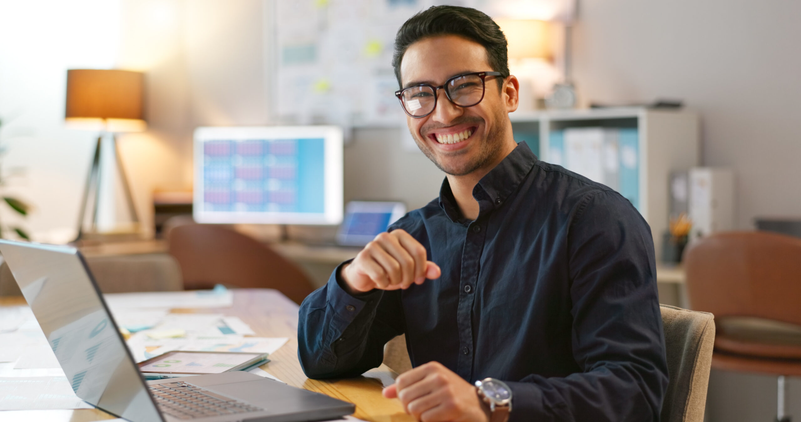 Portrait of happy man in office, typing on laptop and planning online research for creative project at digital agency. Internet, website and networking, businessman with smile and computer for email